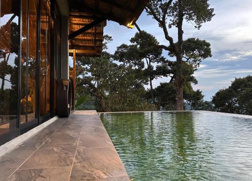 a swimming pool in front of a house at Bao Sheng Durian Farm in Balik Pulau