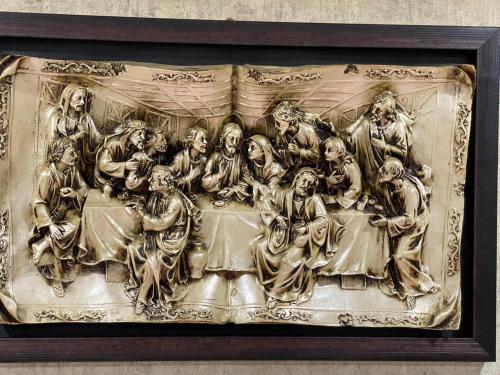 a metal relief of a group of people at Gio Apartment in Tbilisi City