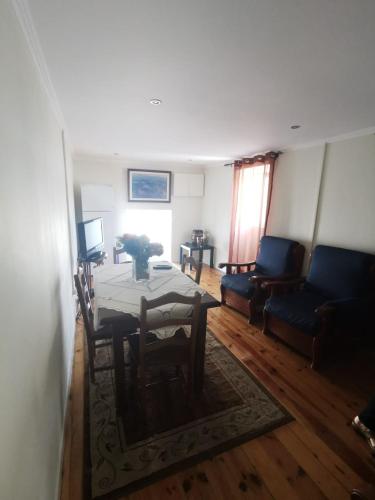 a living room with a table and a couch at O Mercadinho in Poiares
