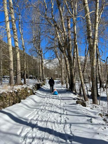 a person walking down a snow covered path at Hotel Rural LA CÁRCEL in Murias de Paredes