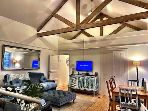 a living room with a couch and a tv at THE MEWS, Millfields Private development & concierge in Plymouth
