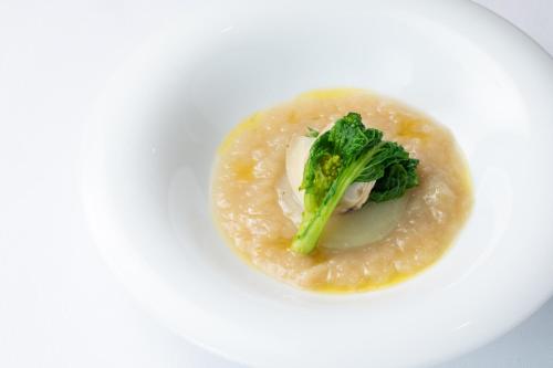 a white plate with a dish of food with broccoli at Matsumoto Hotel Kagetsu in Matsumoto
