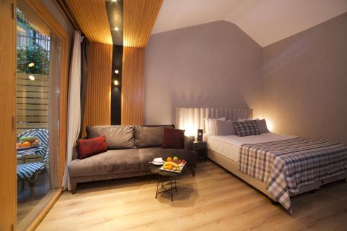 a living room with a bed and a couch at Dosso Dossi Hotels Laleli in Istanbul