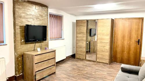 a living room with a tv on a wall at Ultracentral Apartment in Arad