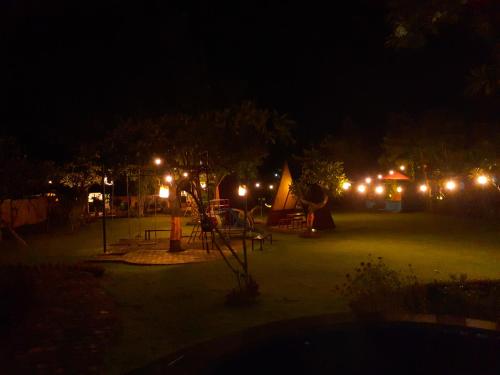 a park at night with a playground with lights at Rich Farmer Eco House and Yoga in Pemuteran