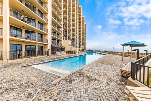 a swimming pool in front of a building at Phoenix X Unit 1211 in Orange Beach