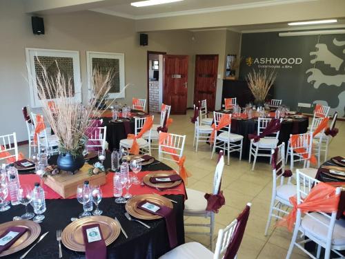 a banquet hall with tables and chairs in a room at Ashwood Groenvlei Boutique Hotel in Bloemfontein