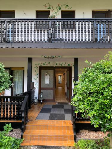 a front porch of a house with a staircase at Gästezimmer - Mespelbrunn in Mespelbrunn