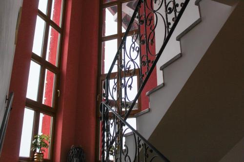 a stairway with windows and a wrought iron railing at Dobranić - Kuća za odmor in Sveti Martin na Muri