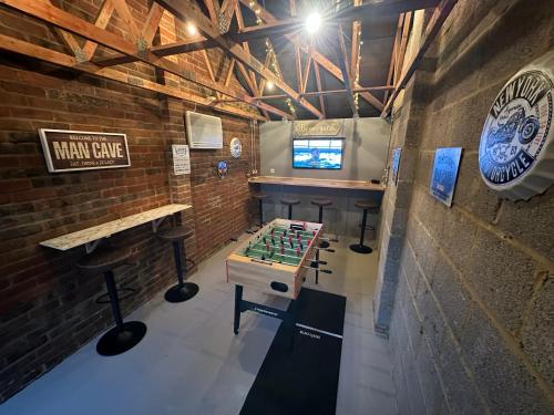 a room with a game table and a bar at 14 Oxford Mews - 5 Star Living for up to 10 People in Southampton