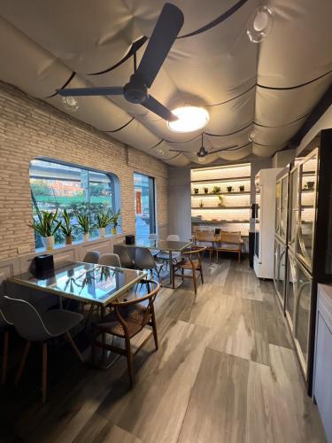 a dining room with tables and chairs and a brick wall at H Hotel in Taipei