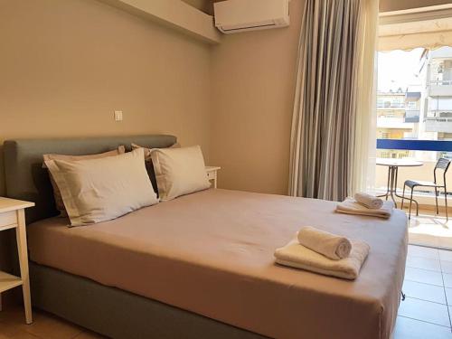 a bedroom with a bed with towels on it at Athens Campus Renovated Studio Apartment @ Ilisia in Athens