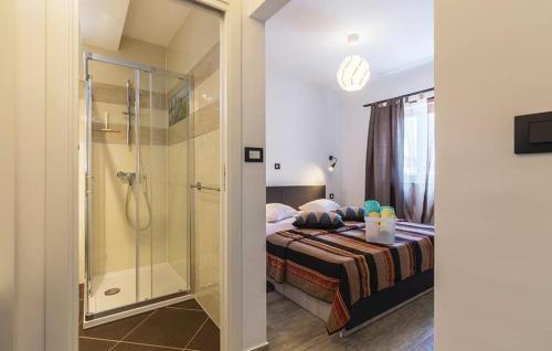 a bedroom with a bed and a glass shower at Villa Mari Apartment in Medulin