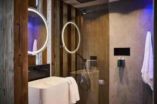 a bathroom with a sink and a mirror at Aparthotel Chalina in Leutasch