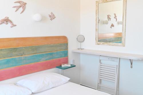 a bedroom with a bed and a mirror at Dolce Vista - Sea View Apartments in Parikia