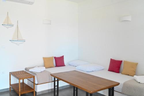 a living room with a couch and a table at Dolce Vista - Sea View Apartments in Parikia