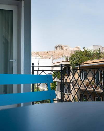 a blue bench sitting on a balcony with a view at Acro Urban Suites in Athens