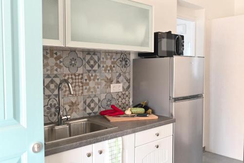 a kitchen with a sink and a refrigerator at Dolce Vista - Sea View Apartments in Parikia