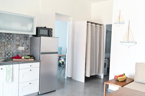 a kitchen with a stainless steel refrigerator in a room at Dolce Vista - Sea View Apartments in Parikia