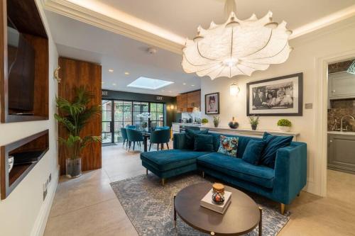 a living room with a blue couch and a table at Westcourt by RMG Apartments in Harrogate