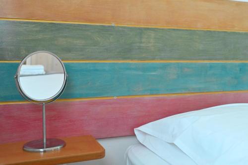 a mirror sitting on a table next to a bed at Dolce Vista - Sea View Apartments in Parikia
