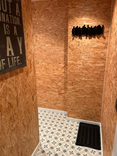 a bathroom with a shower with a sign on the wall at Studio 't Hoveke in Gullegem