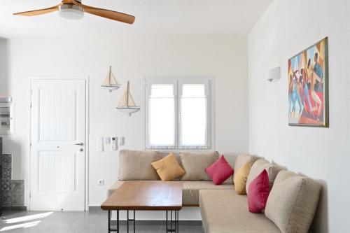 a living room with a couch and a table at Dolce Vista - Sea View Apartments in Parikia