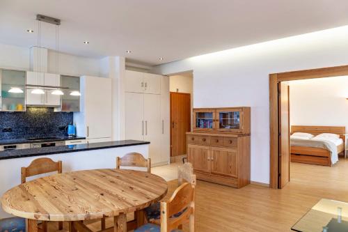 a kitchen and dining room with a wooden table at Haus Excelsior Top 14 in Seefeld in Tirol
