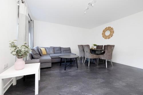 a living room with a couch and a table at Stylish 3BR Home with Garden & Free Parking - Near O2 Academy & City Centre in Glasgow