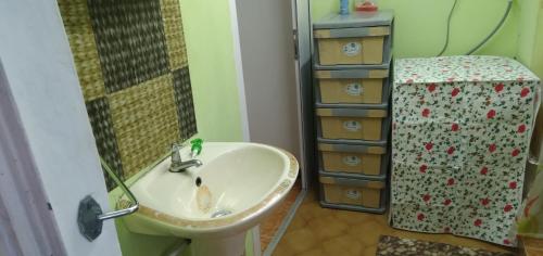 a bathroom with a sink and a mirror at Paradise Resting Home in Réunion