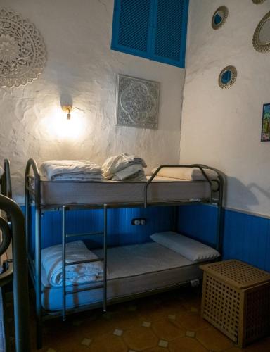 a room with three bunk beds in a room at CASA RURAL HUERTO PERDIDO in Alosno