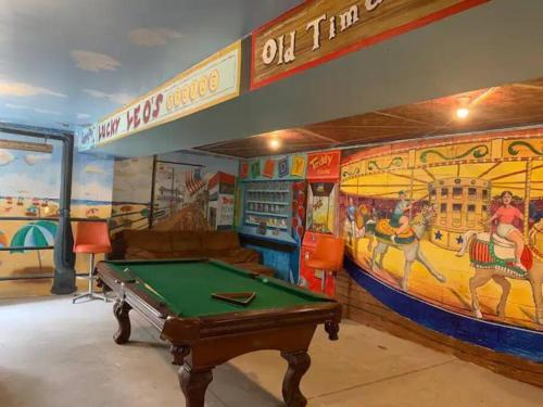a room with a pool table in front of a mural at The Lighthouse-3 Bedroom with Casino Pier Gameroom in Seaside Heights
