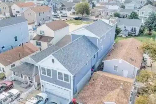 an aerial view of a blue house in a residential neighborhood at The Lighthouse-3 Bedroom with Casino Pier Gameroom in Seaside Heights
