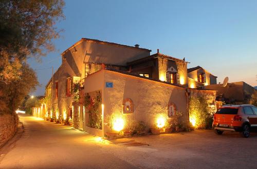 a car parked in front of a building with lights at Venetis Luxury Apartments in Chios