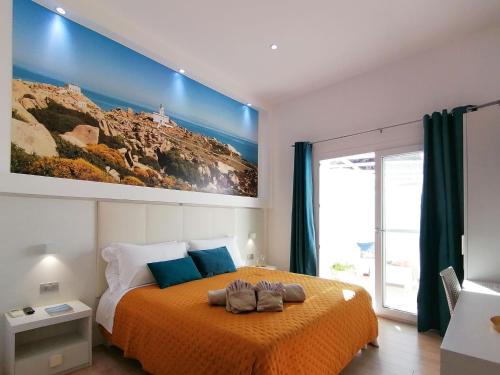 a bedroom with a large bed with an orange blanket at Charme Suite B&B Experience in Santa Teresa Gallura