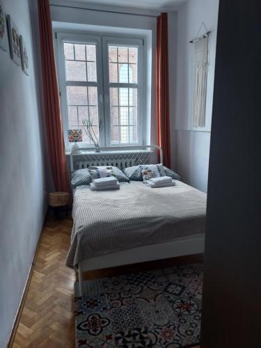 a bedroom with a bed and a window at Apartment in Old Town - view of Mariacki Church in Gdańsk