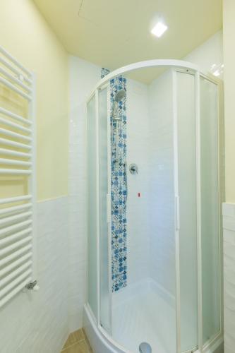a shower with a glass door in a bathroom at Pendici di Fiesole - Appartamento Copperstone in Florence