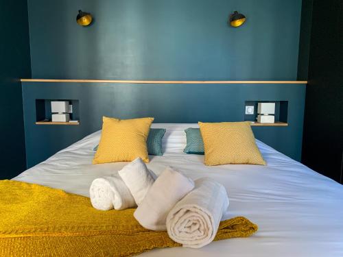 - un grand lit avec des serviettes et des oreillers dans l'établissement Villa Nymphéa - maison avec piscine chauffée St Gildas de Rhuys, à Saint-Gildas-de-Rhuys
