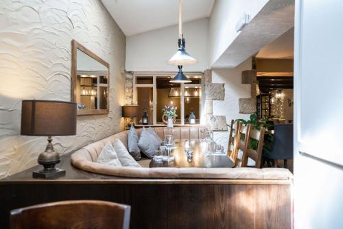 a dining room with a couch and a table at Black Horse Hotel in Grassington