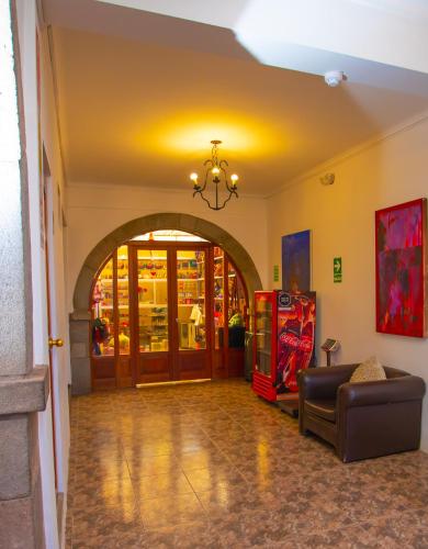 a living room with a couch and an entry way at Centenario Inn in Cusco