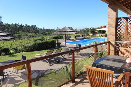 a patio with a table and chairs and a pool at Quinta das Alfambras in Aljezur