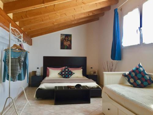 a bedroom with a bed and a table at Casa Merano Residence & Restaurant Bibione Centro in Bibione