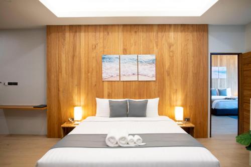 a bedroom with a large bed with two towels at Ao Luek Panoramic Pool-SHA Plus in Ao Luk