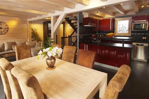 a kitchen and dining room with a wooden table and chairs at Les Drus - Luxury Chalet for 8 in Chamonix-Mont-Blanc