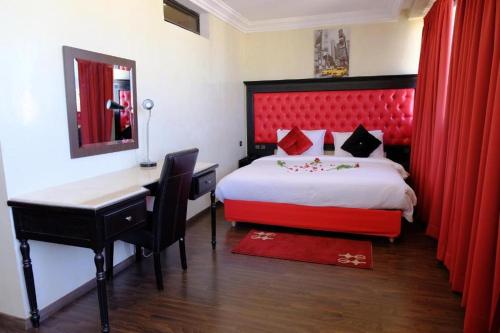 a hotel room with a bed and a desk and a desk at Washington Hotel in Casablanca