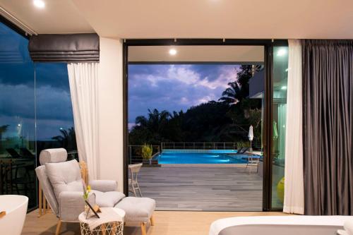 a house with a view of a swimming pool at Ao Luek Panoramic Pool-SHA Plus in Ao Luk