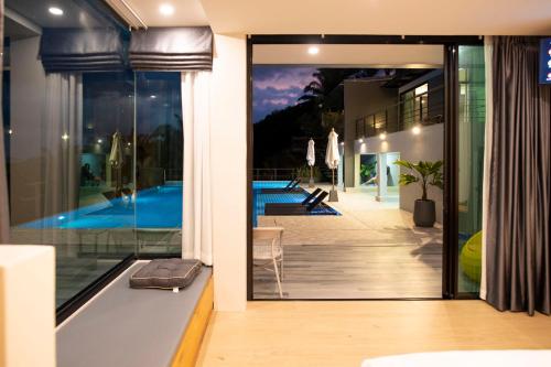 a house with a view of a swimming pool at Ao Luek Panoramic Pool-SHA Plus in Ao Luk