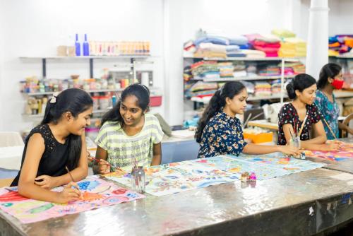 a group of women sitting at a table making crafts at Villa Hundira in Negombo