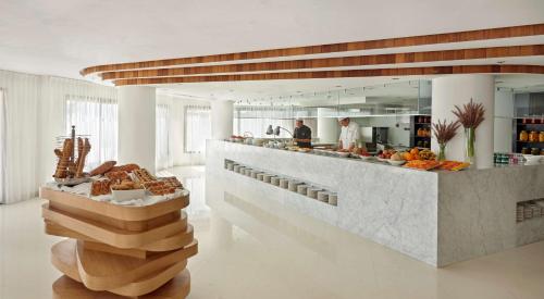 a kitchen with a counter with a bunch of food at Hyatt Place Taghazout Bay in Taghazout