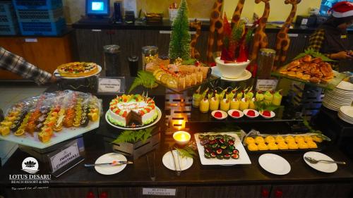a display case with many different types of desserts at Lotus Desaru Beach Resort & Spa in Desaru